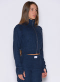 front right side profile view of a model wearing the Cloud Full Length Jacket in Sapphire Blue color