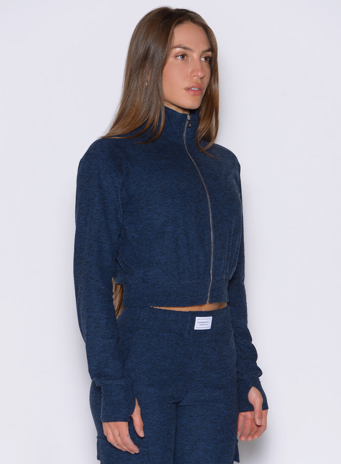 front right side profile view of a model wearing the Cloud Full Length Jacket in Sapphire Blue color