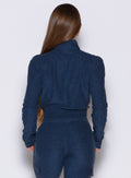 back profile view of a model wearing the Cloud Full Length Jacket in Sapphire Blue color