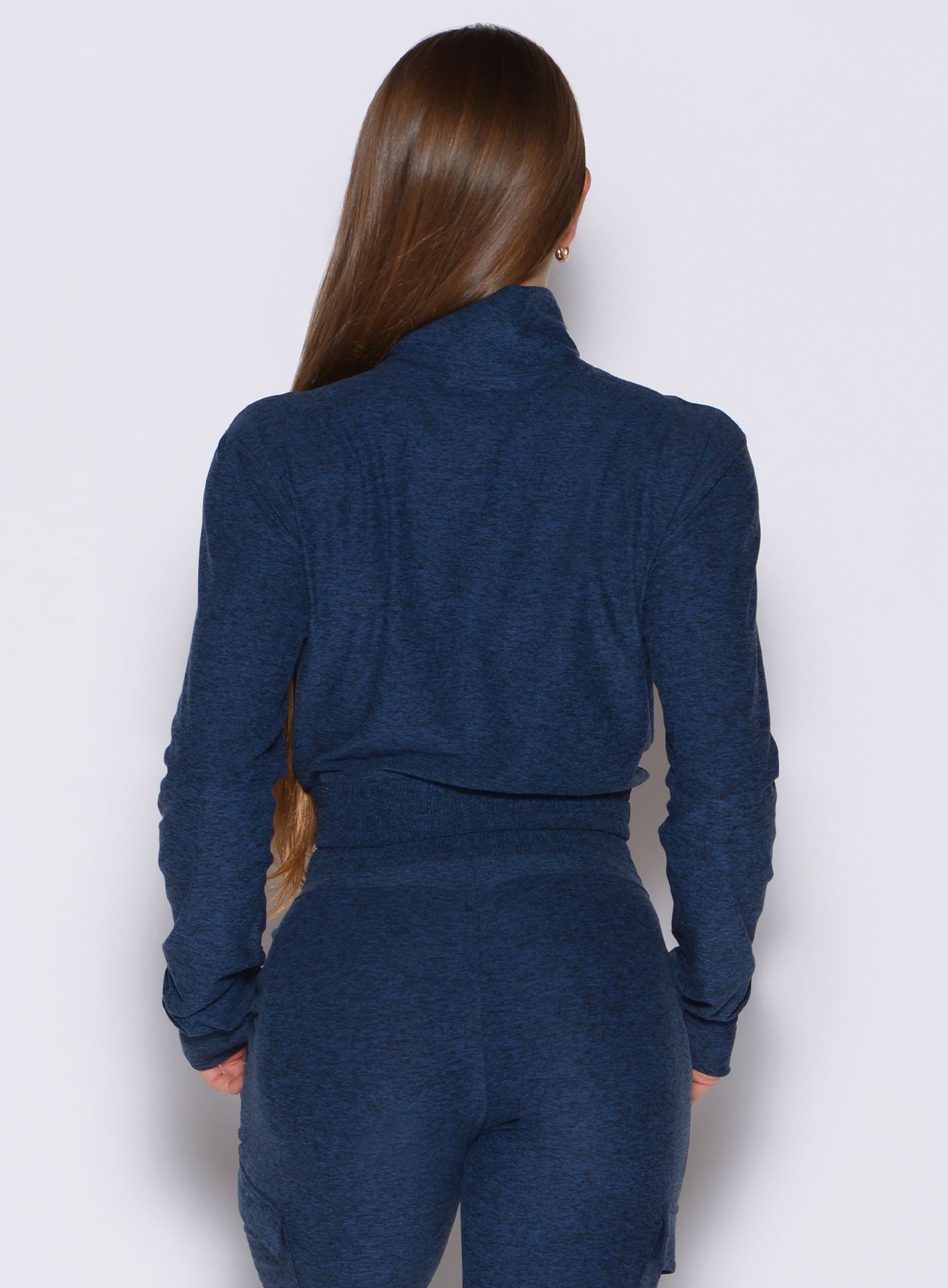 back profile view of a model wearing the Cloud Full Length Jacket in Sapphire Blue color