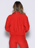 back profile view of a model wearing the Cloud Full Length Jacket in scarlet red color