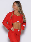 front profile view of a model facing to the right side wearing the Cloud Full Length Jacket in scarlet red color