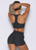 back profile view of a model wearing the Cloud Lounge Bra in Charcoal color