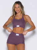 frontal view of a model with both hands on her waist wearing the Cloud Lounge Bra in regal purple color