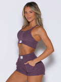 front left side profile view of a model wearing the Cloud Lounge Bra in regal purple color paired with the matching shorts 