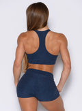 back side view of a model wearing the Cloud Lounge Bra in Sapphire Blue color