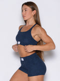 left side profile view of a model wearing the Cloud Lounge Bra in Sapphire Blue color