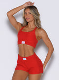 front view of a model with one hand resting on top of her head wearing the Cloud Lounge Bra in scarlet red color