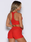 back profile view of a model facing to the right side wearing the Cloud Lounge Bra in scarlet red color