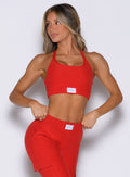 front view of a model looking to the right side wearing the Cloud Lounge Bra in scarlet red color