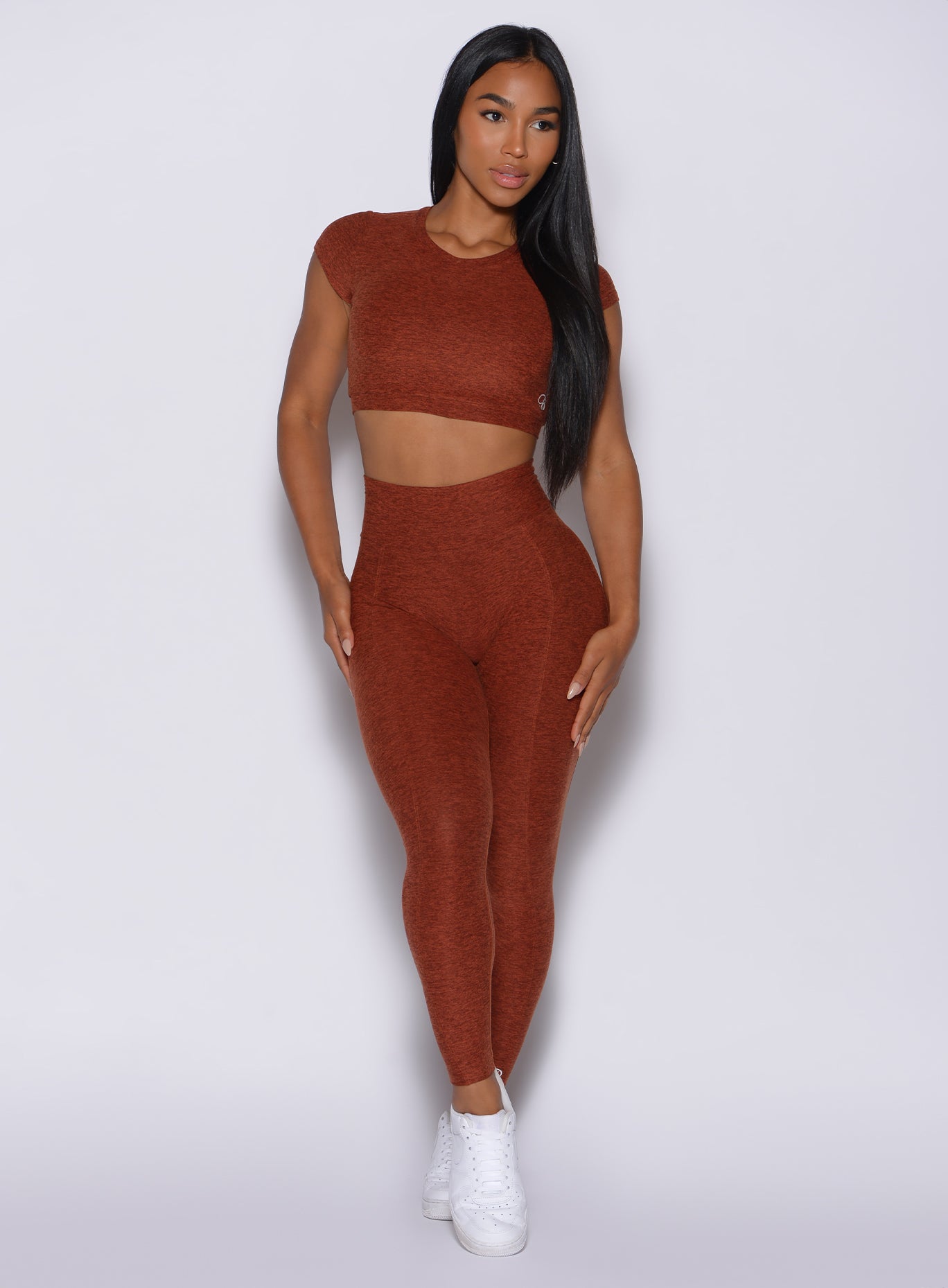 Front profile view of a model in our cloud leggings in Cinnamon color and a matching top