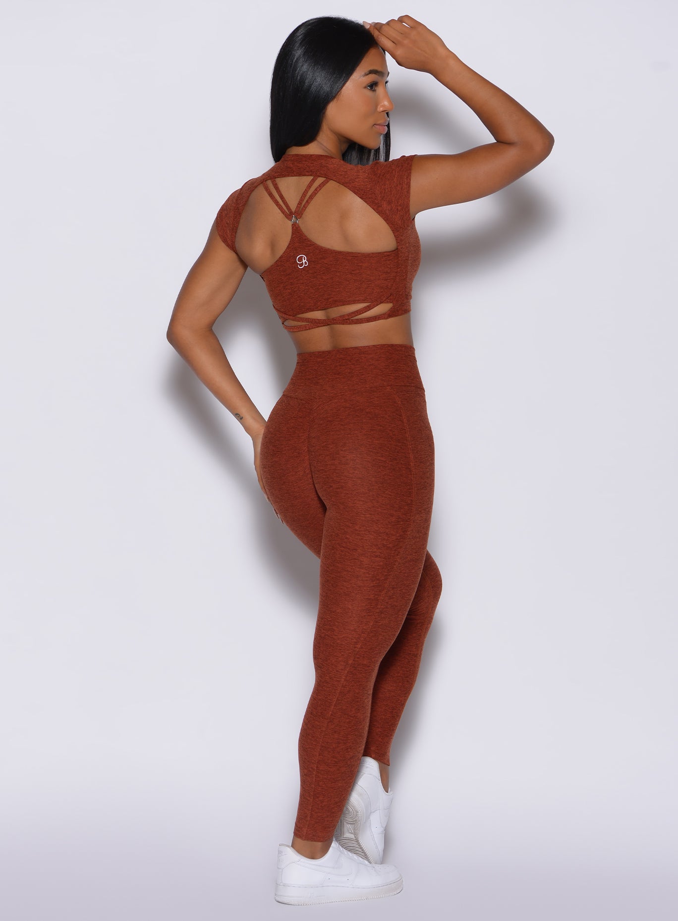 Back profile view of a model in our cloud leggings in Cinnamon color and a matching bra