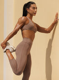 Cocoa Ace Bra with sculpting support and crossover back during outdoor stretch training pose