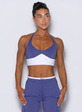 Front view of model looking left wearing Bombshell Sportswear Confidence bra top in Future Dusk color, featuring sculpting supportive fit and cleavage-enhancing front