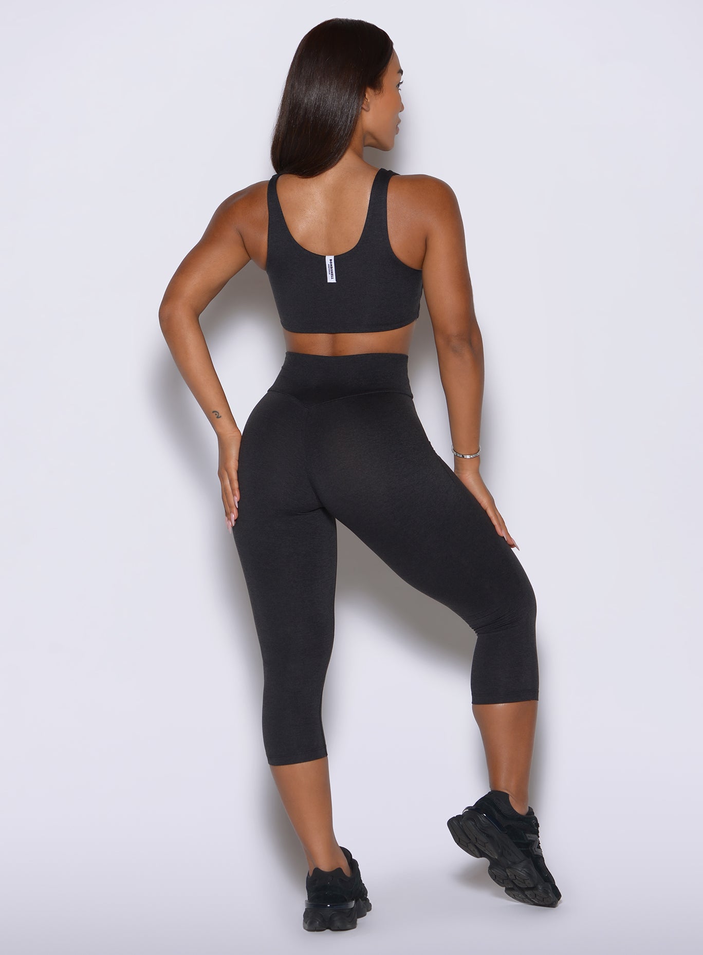 Rear view of the black Contour capris showing the glute enhancing scrunch and smooth fit