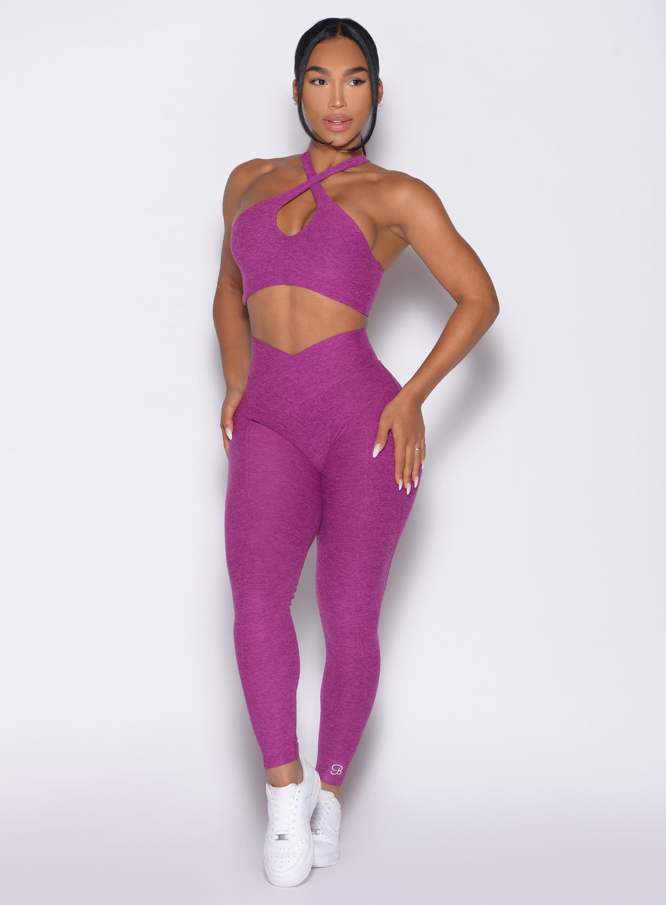 Seamless Bright Plum Contour Leggings paired with a matching halter sports bra for yoga sessions.