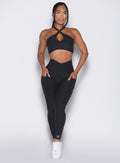 front profile view of a model wearing our Contour Leggings and the matching Cross Over Halter Bra in Heathered Black color