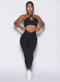 Model facing forward wearing our Contour Leggings and the matching Cross Over Halter Bra in Heathered Black color