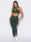 Model facing forward wearing our Contour Leggings and the matching Cross Over Halter Bra in Pine color
