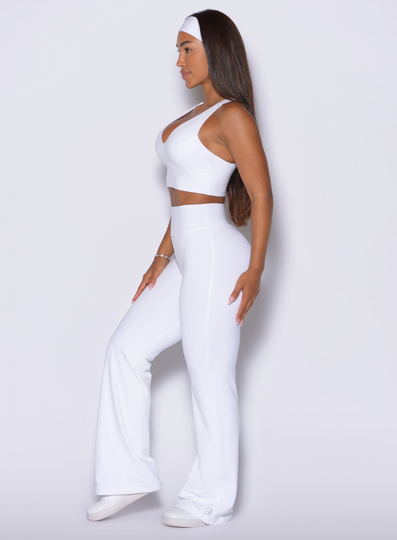 Sleek left profile emphasizes the flawless, tailored hang of medium-weight white trousers.