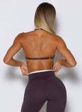 back profile view of a model wearing the Contrast Voltage Sports Bra in black orchid color