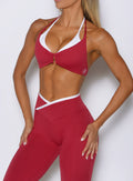 close up front view of a model wearing the Contrast Voltage Sports Bra in maroon color