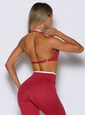 back profile view of a  model wearing the Contrast Voltage Sports Bra in maroon color