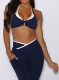 close up front profile view of a model wearing the Contrast Voltage Sports Bra in Navy color