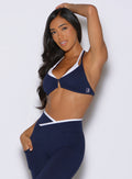 front view of a model wearing the Contrast Voltage Sports Bra in Navy color