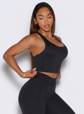 Side view of the heathered black Core Comfort Tank with a racerback and relaxed performance fit.