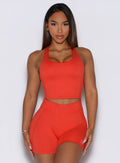 A front view shot of the model wearing the Core Comfort Tank in Inferno color, paired with matching shorts.
