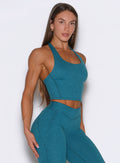 Front right side shot of the model wearing our Core Comfort Tank in Seafoam color.