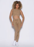 front profile view of a model wearing the Charm Fit Leggings in sandstone color