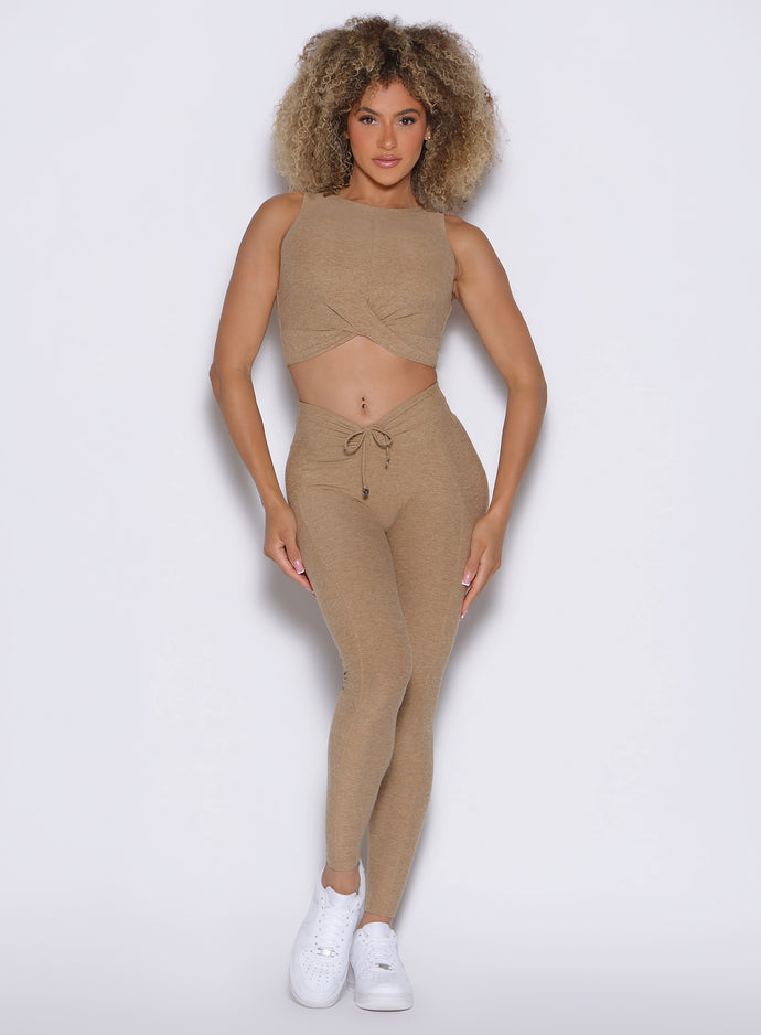 front profile view of a model wearing the Charm Fit Leggings in sandstone color