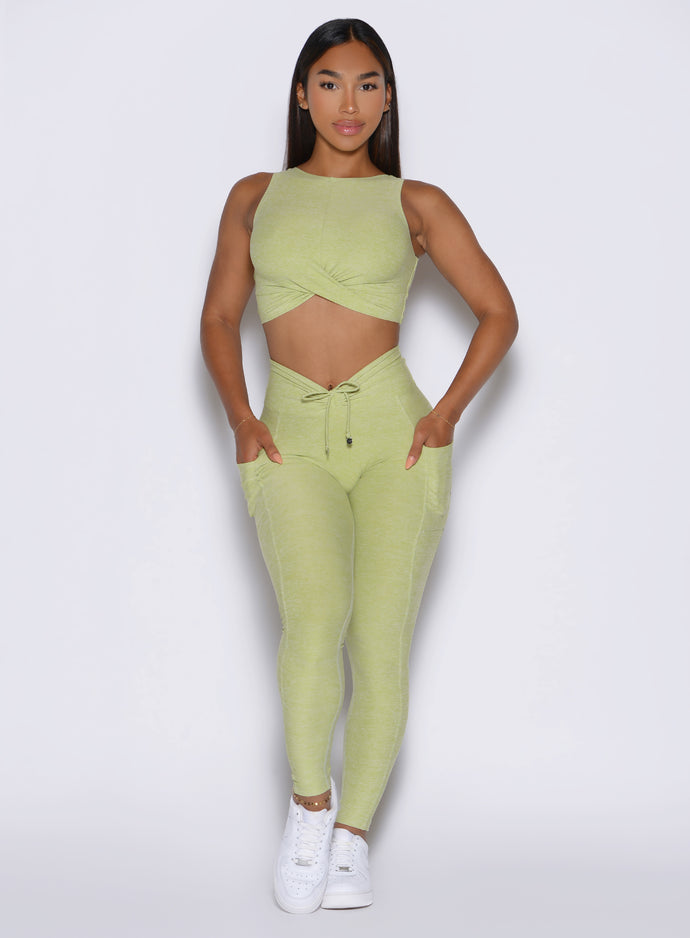 front view of a model wearing the Charm Fit Leggings in serpentine color paired with the matching top