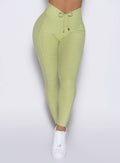 close up front view of a model wearing the Charm Fit Leggings in serpentine color