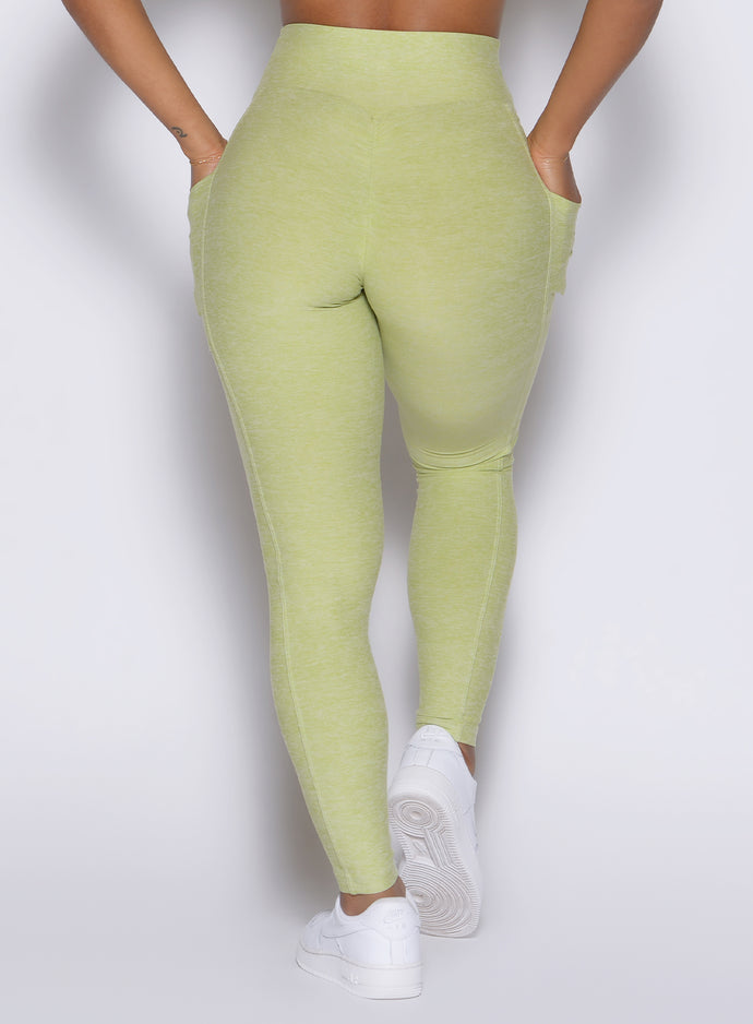 close up back profile view of a model wearing the Charm Fit Leggings in serpentine color