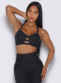 front view of a model wearing our core set bra in heather black color along with the matching leggings