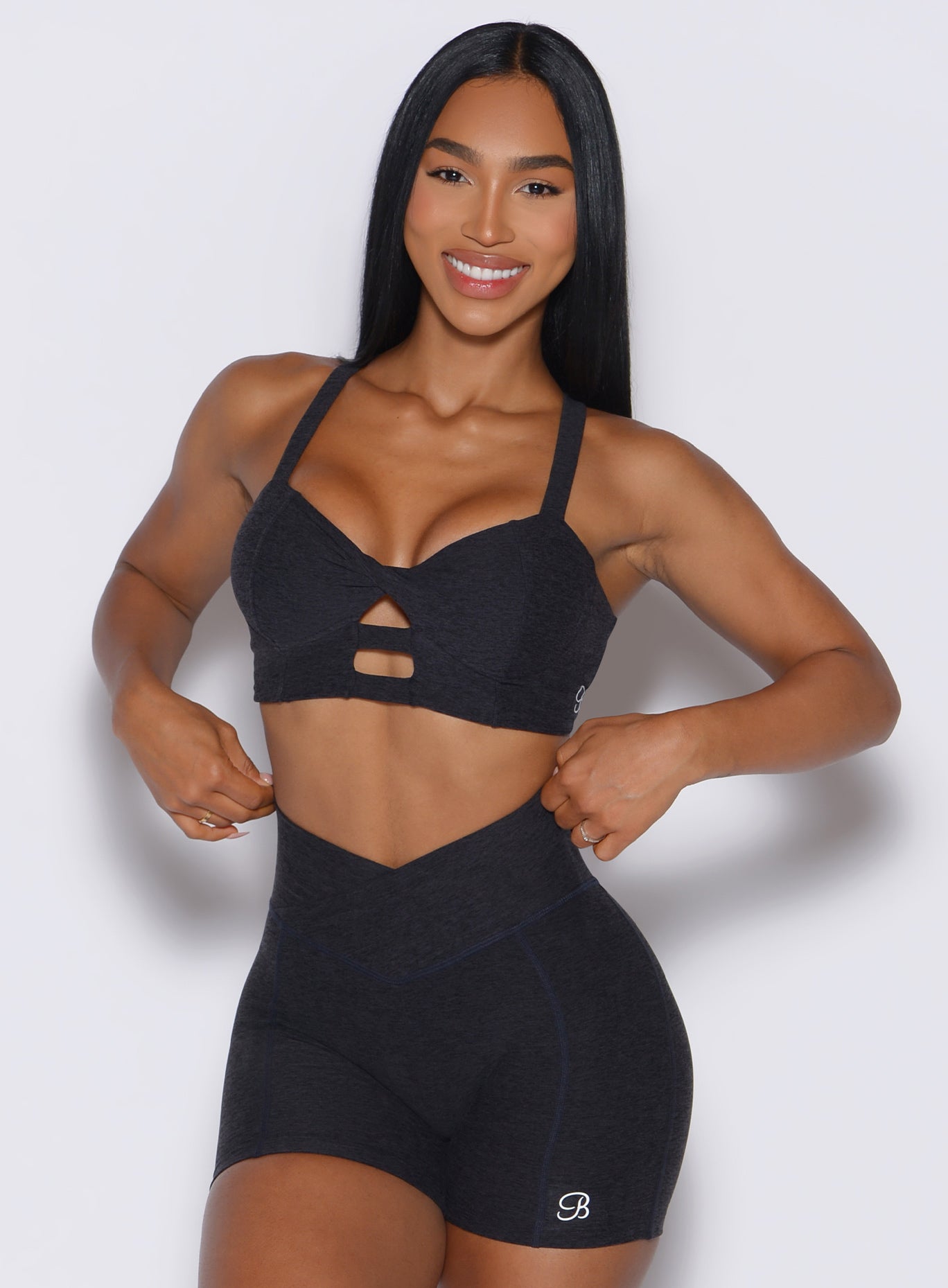 front view of a model wearing our core set bra in heather black color along with the matching shorts