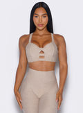 front profile view of a model wearing our core set bra in taupe color along with the matching Leggings