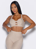 front profile view of a model wearing our core set bra in taupe color along with the matching Leggings
