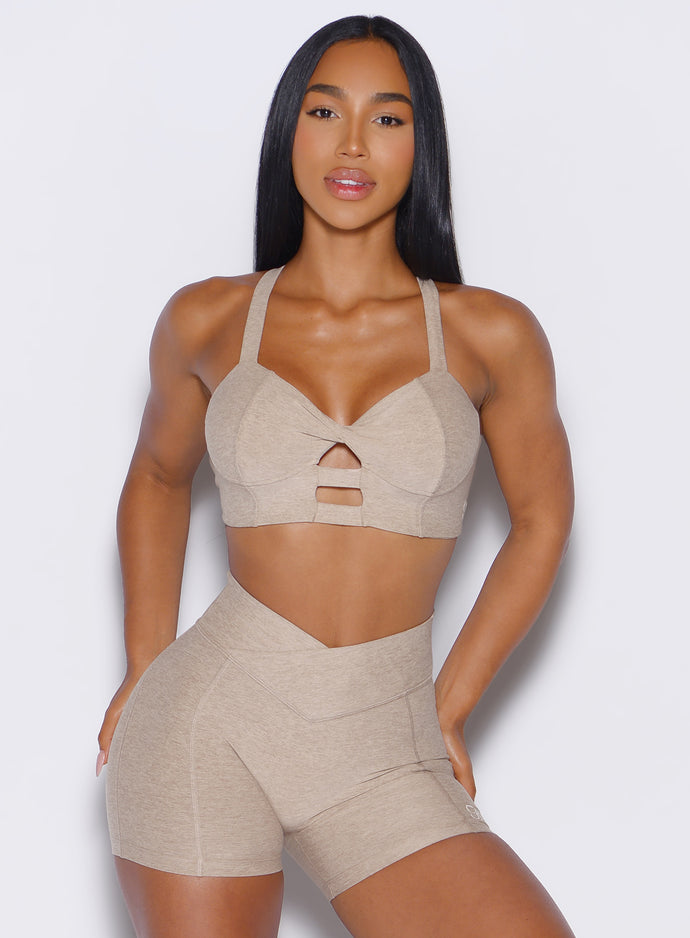 front profile view of a model wearing our core set bra in taupe color along with the matching shorts
