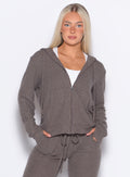 front profile view of model with hands in her jogger pockets wearing the Gym Crush Hoodie in Cozy Chocolate color