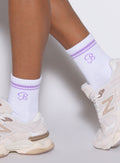 Left side view of violet Crew Socks, featuring a ribbed, moisture-wicking athletic performance fit.