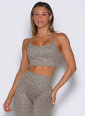 front profile view of a model wearing the Cross Fit Bra in Nori cheetah color paired with the matching leggings 