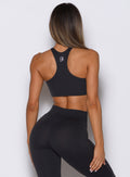 Sculpting Heathered Black Cross Over Halter Bra with skinny racerback for high-impact training.