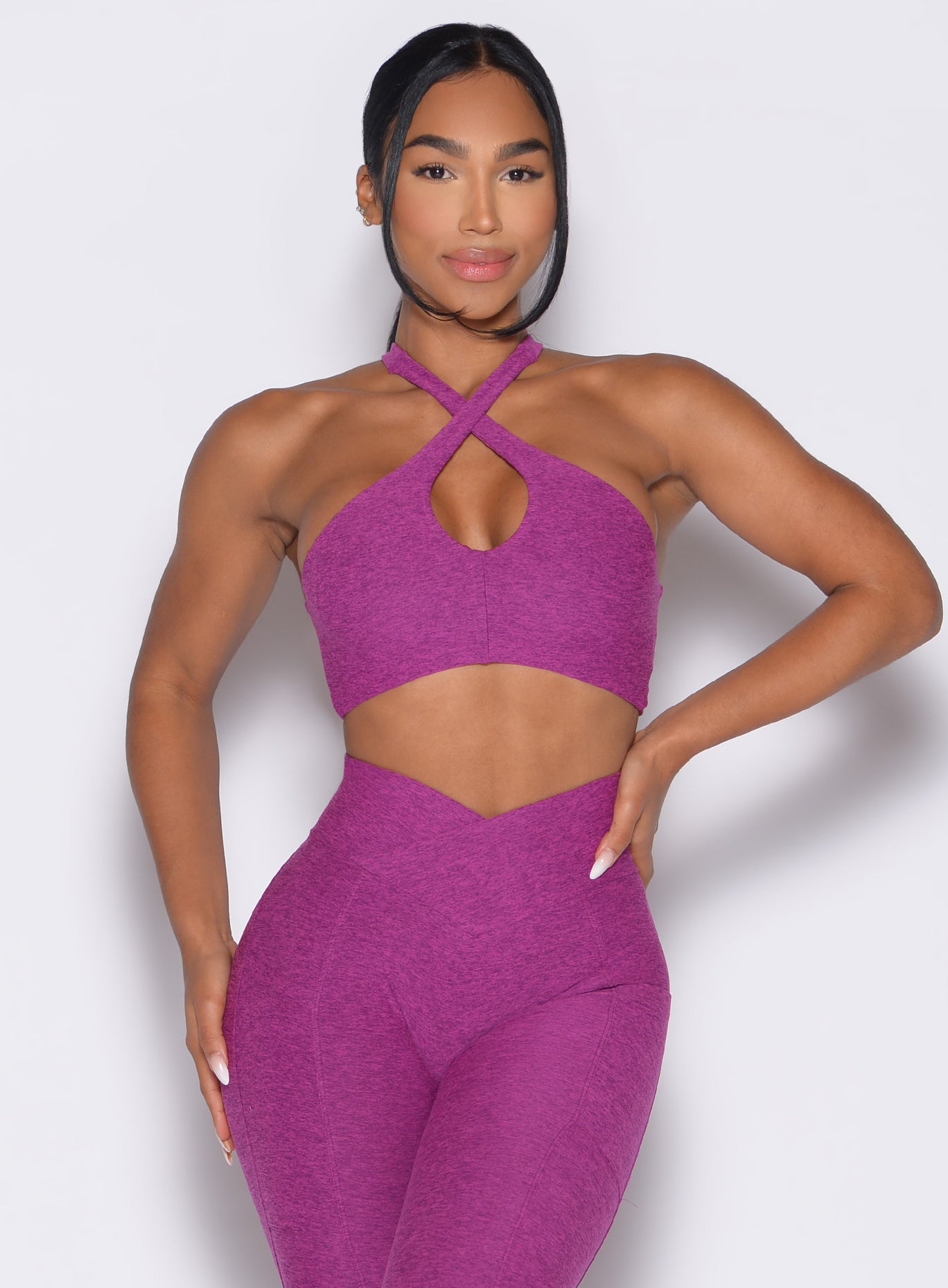 Bright Plum Cross Over Halter Bra with a front keyhole and matching high-waisted gym leggings.