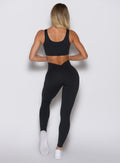 Back profile view of a model wearing the Curvemax Leggings in Black color