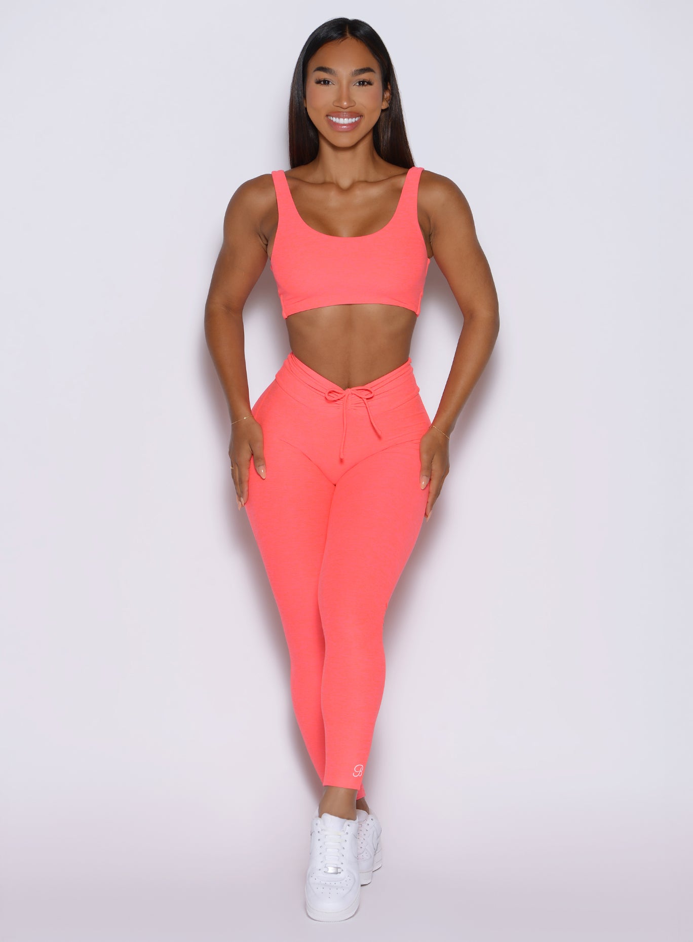 Front view of neon apricot pink Curvemax Leggings, high-waisted sculpting gym activewear.