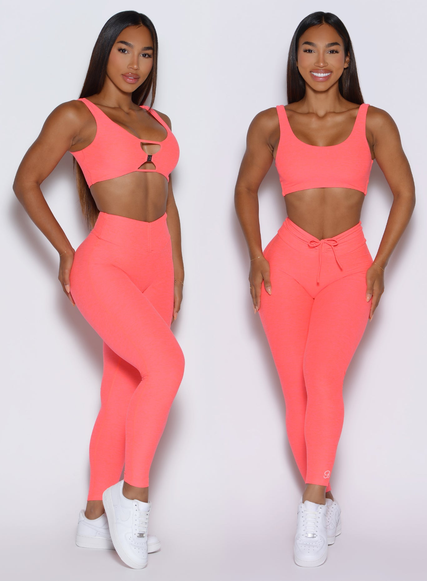 front profile view of a model showcasing the straight and V cut waistband side by side wearing the Curvemax leggings in neon apricot pink color 